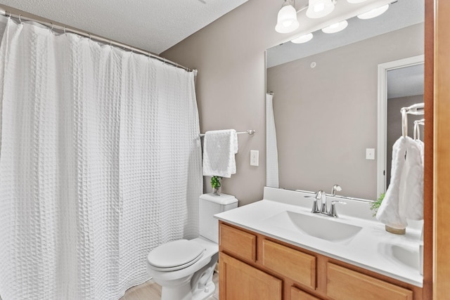 2119 Cedar Grove Trl, Eagan, MN 55122 - full bathroom with vanity, toilet, a textured ceiling, and a shower with shower curtain