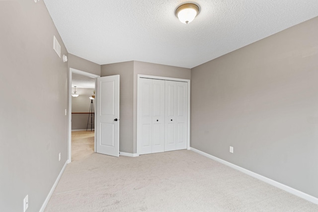 2119 Cedar Grove Trl, Eagan, MN 55122 - unfurnished bedroom featuring a textured ceiling, light carpet, and a closet