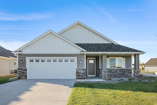 17795 Hoover St NW, Elk River, MN 55330 - craftsman-style house with stone siding, a garage, a front lawn, and concrete driveway