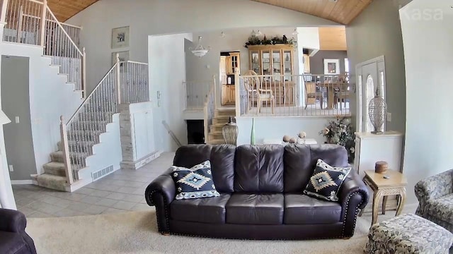 14473 Barnes Dr, Lake View Twp, MN 56501 - living room featuring vaulted ceiling, stairs, tile patterned floors, and wood ceiling