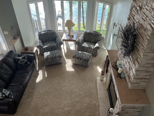 14473 Barnes Dr, Lake View Twp, MN 56501 - carpeted living area with a tile fireplace