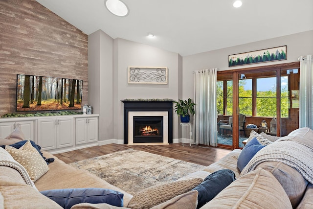 W10415 521st Ave, Prescott, WI 54021 - living area featuring high vaulted ceiling, a lit fireplace, light wood-style floors, and baseboards