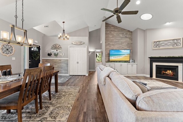 W10415 521st Ave, Prescott, WI 54021 - living room featuring a chandelier, ceiling fan, high vaulted ceiling, dark wood finished floors, and a glass covered fireplace