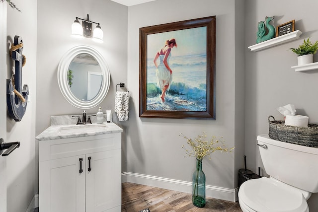 W10415 521st Ave, Prescott, WI 54021 - bathroom with baseboards, wood finished floors, vanity, and toilet