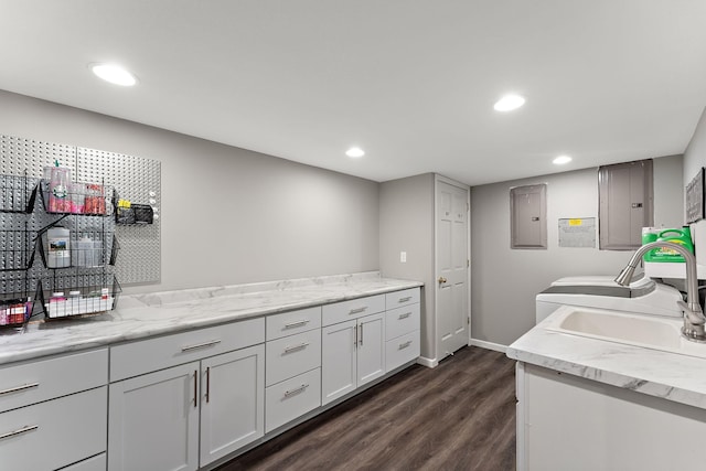 W10415 521st Ave, Prescott, WI 54021 - washroom with electric panel, dark wood-type flooring, recessed lighting, baseboards, and cabinet space