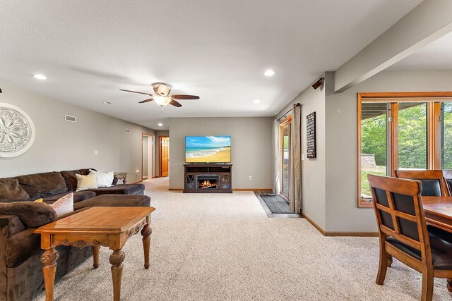 W10415 521st Ave, Prescott, WI 54021 - living room with light carpet, recessed lighting, a ceiling fan, baseboards, and healthy amount of natural light