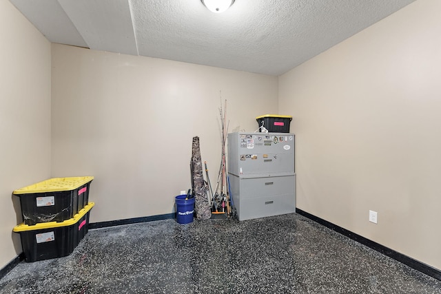 W10415 521st Ave, Prescott, WI 54021 - miscellaneous room with baseboards, speckled floor, and a textured ceiling