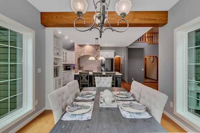 dining area with light wood finished floors and baseboards
