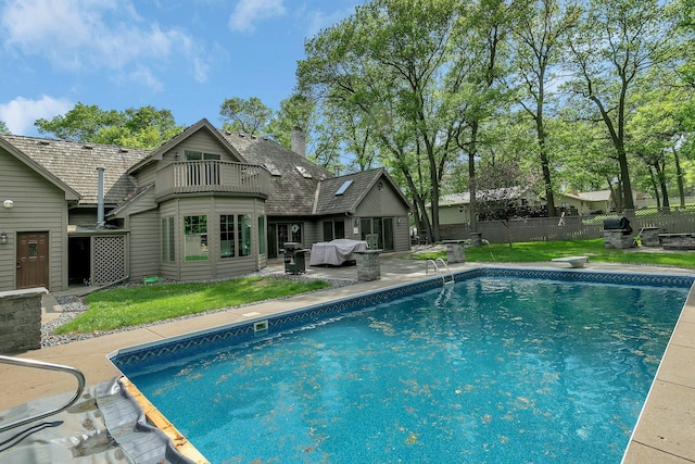 view of swimming pool with a patio area and grilling area