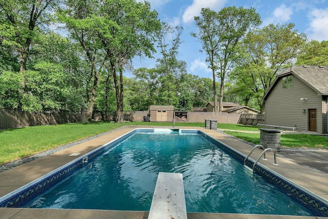 view of swimming pool with a storage unit, an outdoor structure, and a diving board