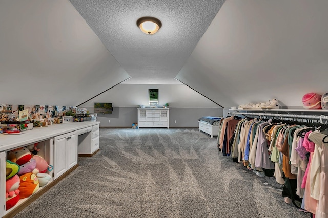 walk in closet featuring carpet and lofted ceiling