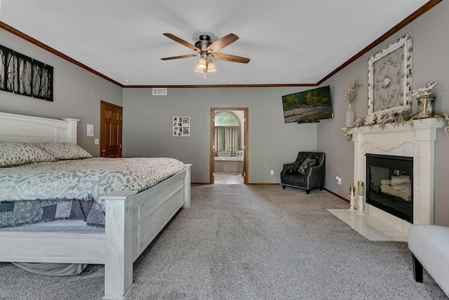 bedroom featuring ornamental molding, carpet, baseboards, a tile fireplace, and ceiling fan