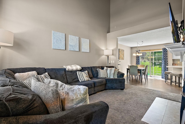 living room featuring carpet floors and a chandelier