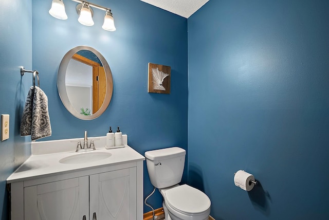 half bathroom featuring toilet and vanity