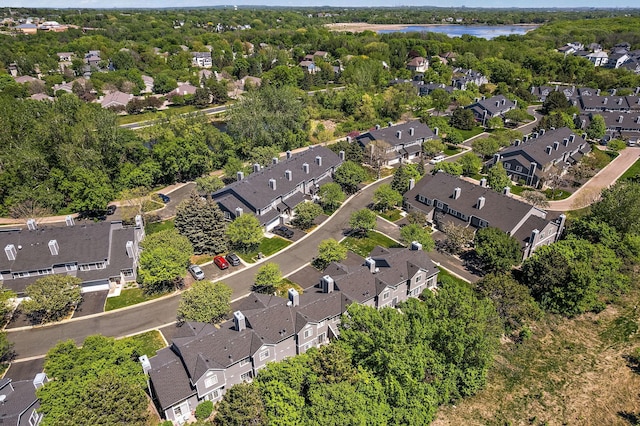 aerial overview of property's location featuring nearby suburban area and a nearby body of water