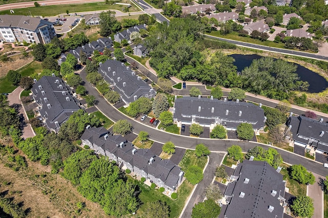 aerial view of property and surrounding area with nearby suburban area and a nearby body of water
