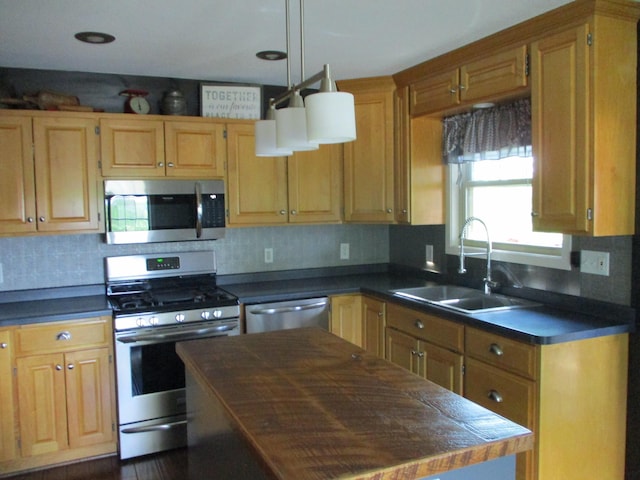 8300 263rd St, Saint Cloud, MN 56301 - kitchen with stainless steel appliances, a sink, dark countertops, and tasteful backsplash