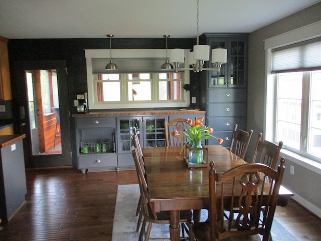 8300 263rd St, Saint Cloud, MN 56301 - dining room featuring healthy amount of natural light, dark wood-style floors, baseboards, and a chandelier