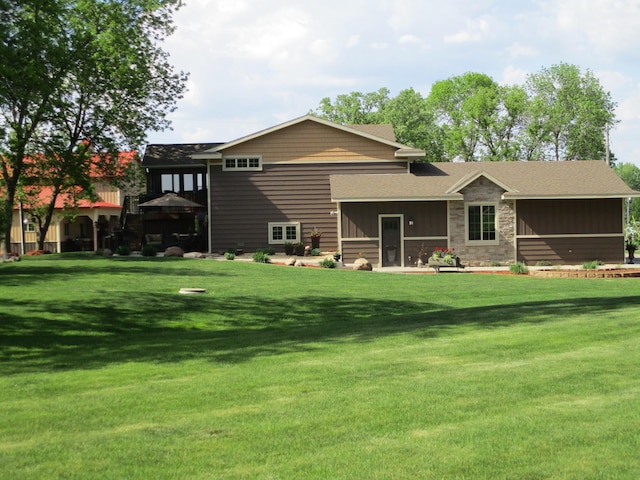 8300 263rd St, Saint Cloud, MN 56301 - back of property featuring a yard, stone siding, and board and batten siding