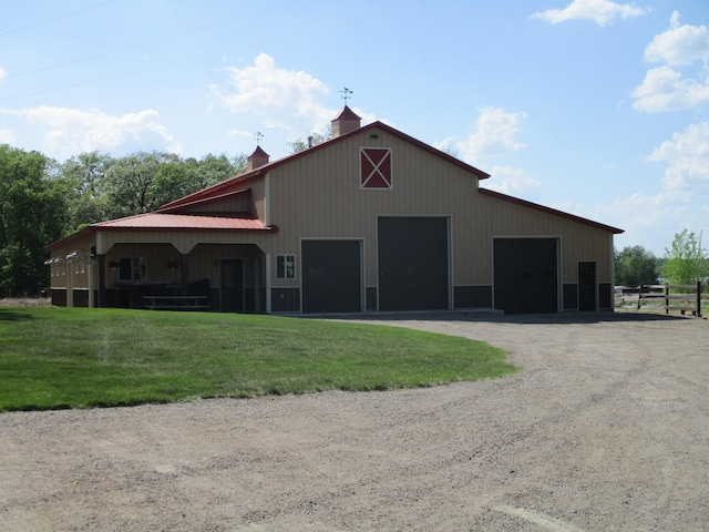 8300 263rd St, Saint Cloud, MN 56301 - view of building exterior featuring fence, driveway, and a detached garage