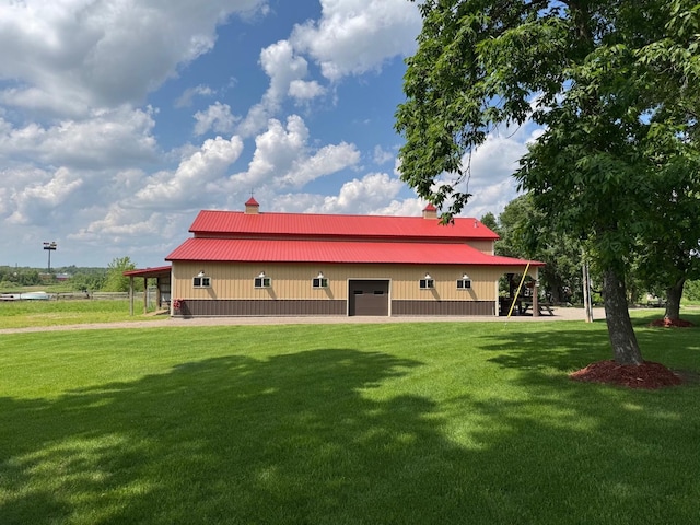8300 263rd St, Saint Cloud, MN 56301 - back of house with a lawn, metal roof, a detached garage, and a pole building