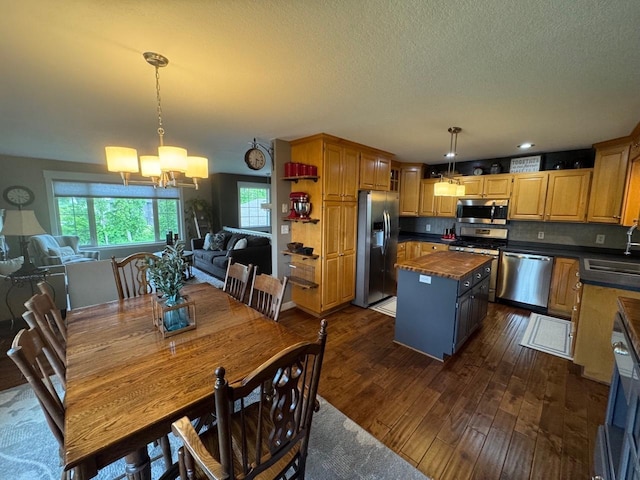 8300 263rd St, Saint Cloud, MN 56301 - dining room featuring a chandelier, dark wood-type flooring, and a textured ceiling