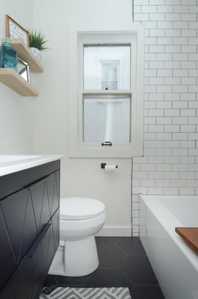 1459 Maywood St, Saint Paul, MN 55117 - full bath with tile patterned flooring, toilet, a bath, baseboards, and vanity
