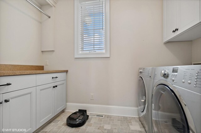 23380 127th St, Glenwood, MN 56334 - washroom with baseboards, washing machine and clothes dryer, and cabinet space