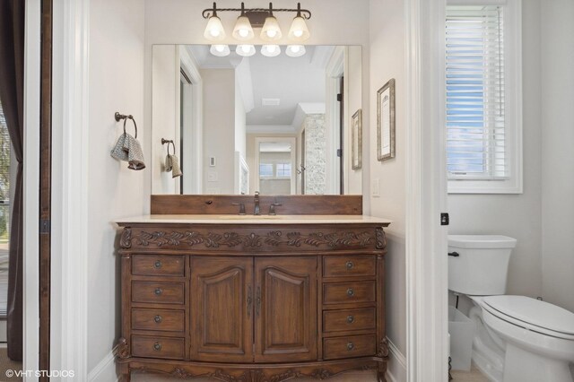 23380 127th St, Glenwood, MN 56334 - bathroom with crown molding, baseboards, toilet, and vanity