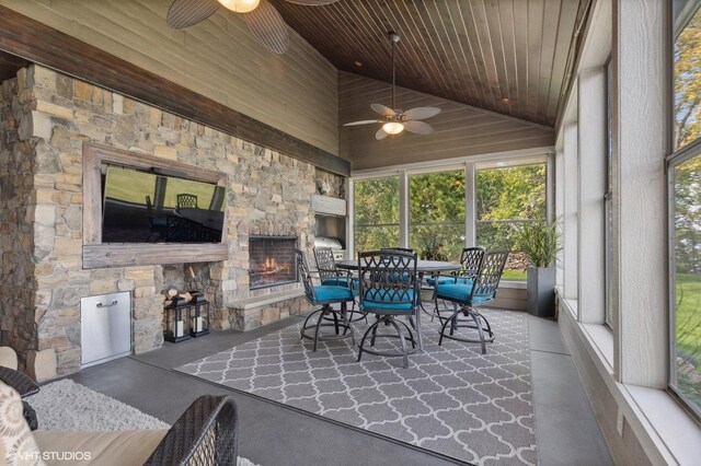 23380 127th St, Glenwood, MN 56334 - sunroom with a stone fireplace, ceiling fan, lofted ceiling, and outdoor dining area