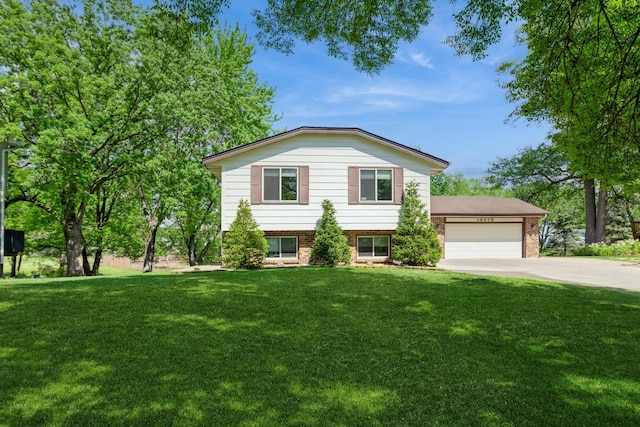 13073 Eldorado St NE, Blaine, MN 55449 - tri-level home featuring a garage, concrete driveway, brick siding, and a front yard