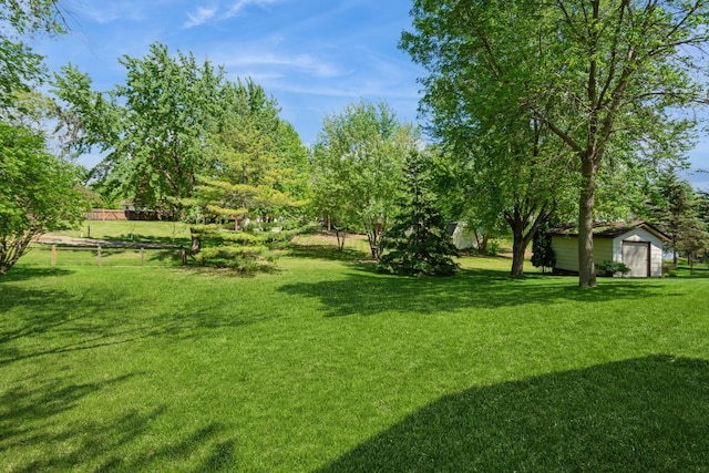 13073 Eldorado St NE, Blaine, MN 55449 - view of yard featuring an outdoor structure, a storage unit, and a garage