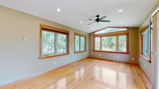 13073 Eldorado St NE, Blaine, MN 55449 - spare room with healthy amount of natural light, light wood-type flooring, lofted ceiling, a ceiling fan, and baseboards