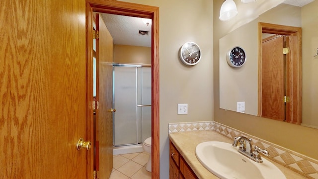 13073 Eldorado St NE, Blaine, MN 55449 - full bath with a stall shower, vanity, tile patterned flooring, toilet, and a textured ceiling