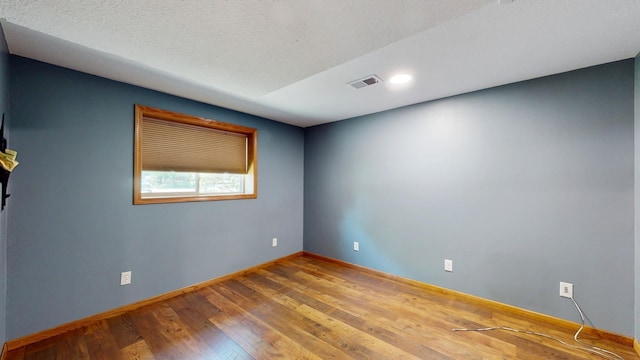 13073 Eldorado St NE, Blaine, MN 55449 - spare room featuring wood finished floors, baseboards, and recessed lighting