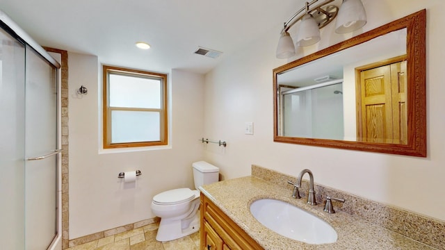 13073 Eldorado St NE, Blaine, MN 55449 - bathroom featuring a stall shower, toilet, vanity, and stone finish floors