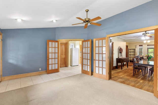 spare room with french doors, ceiling fan, lofted ceiling, and baseboards