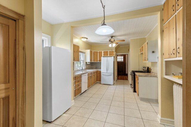 kitchen featuring white appliances, light tile patterned flooring, a ceiling fan, a sink, and ornamental molding