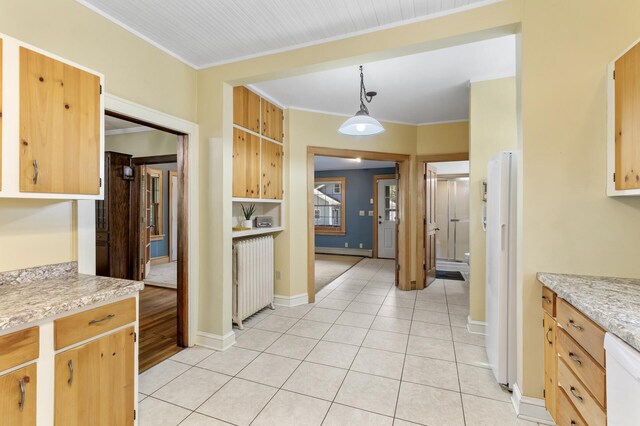 kitchen with radiator heating unit, white appliances, light countertops, light tile patterned flooring, and crown molding