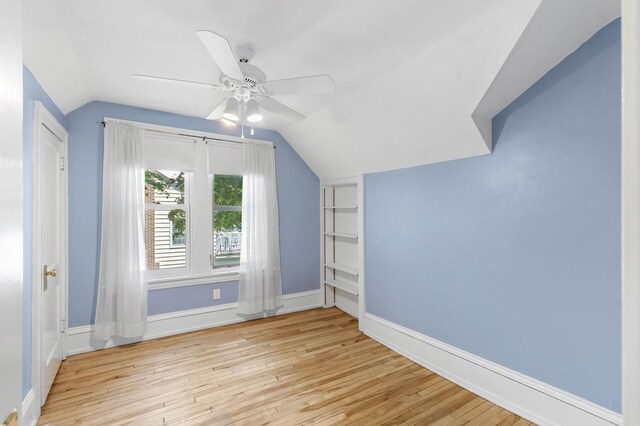 bonus room featuring vaulted ceiling, a ceiling fan, wood finished floors, and baseboards