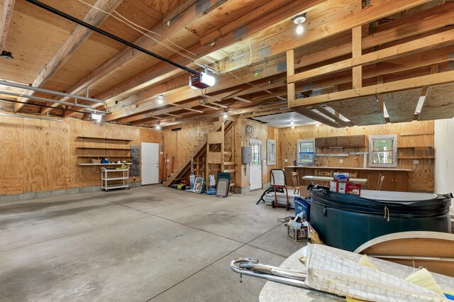 garage featuring wood walls and a garage door opener