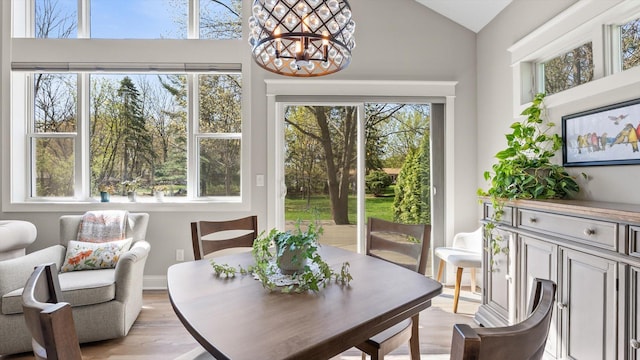 2356 Laport Dr, Mounds View, MN 55112 - dining area featuring a chandelier, lofted ceiling, and light wood-style flooring