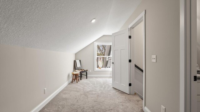 2356 Laport Dr, Mounds View, MN 55112 - bonus room featuring vaulted ceiling, light carpet, baseboards, and a textured ceiling