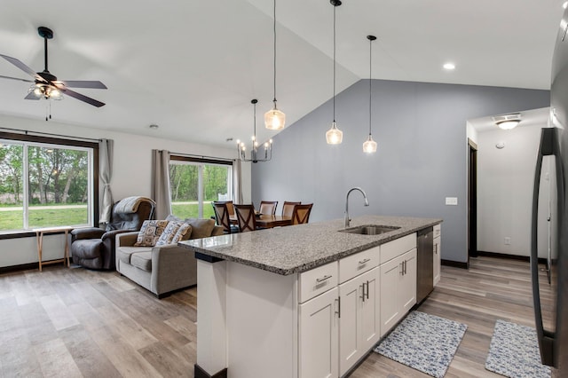 508 14th St NW, Waseca, MN 56093 - kitchen featuring a sink, stainless steel dishwasher, vaulted ceiling, open floor plan, and light wood-type flooring
