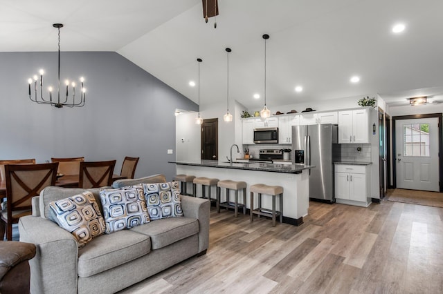 508 14th St NW, Waseca, MN 56093 - living area with a chandelier, light wood-style floors, recessed lighting, and high vaulted ceiling
