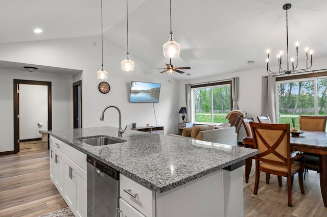 508 14th St NW, Waseca, MN 56093 - kitchen featuring stainless steel dishwasher, a sink, light wood finished floors, a kitchen island with sink, and vaulted ceiling