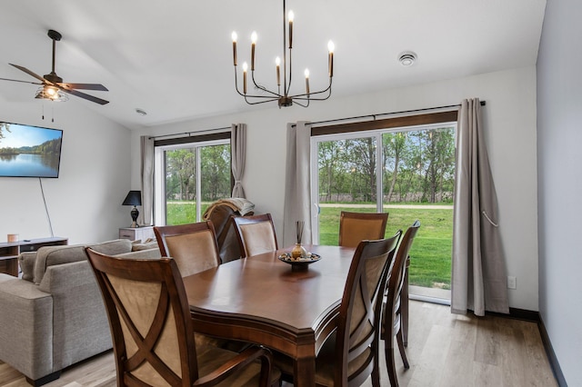 508 14th St NW, Waseca, MN 56093 - dining space featuring light wood finished floors, a chandelier, vaulted ceiling, and ceiling fan