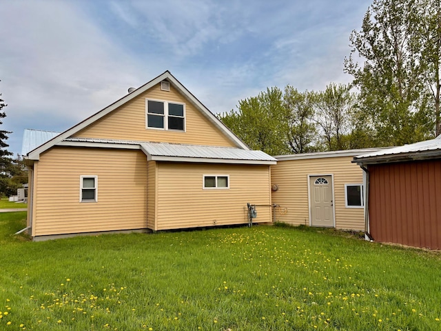 113 6th Ave SE, Baudette, MN 56623 - back of house featuring a yard and metal roof
