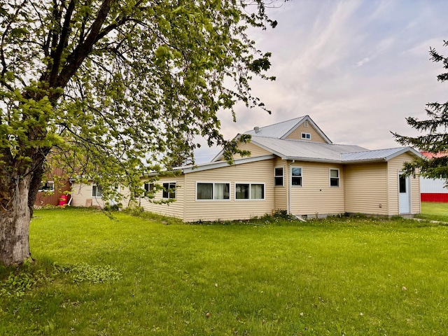 113 6th Ave SE, Baudette, MN 56623 - rear view of property with a lawn and metal roof