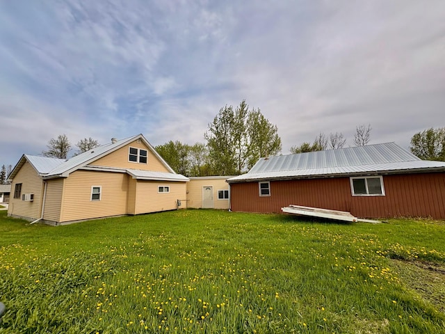 113 6th Ave SE, Baudette, MN 56623 - back of house with a yard and metal roof